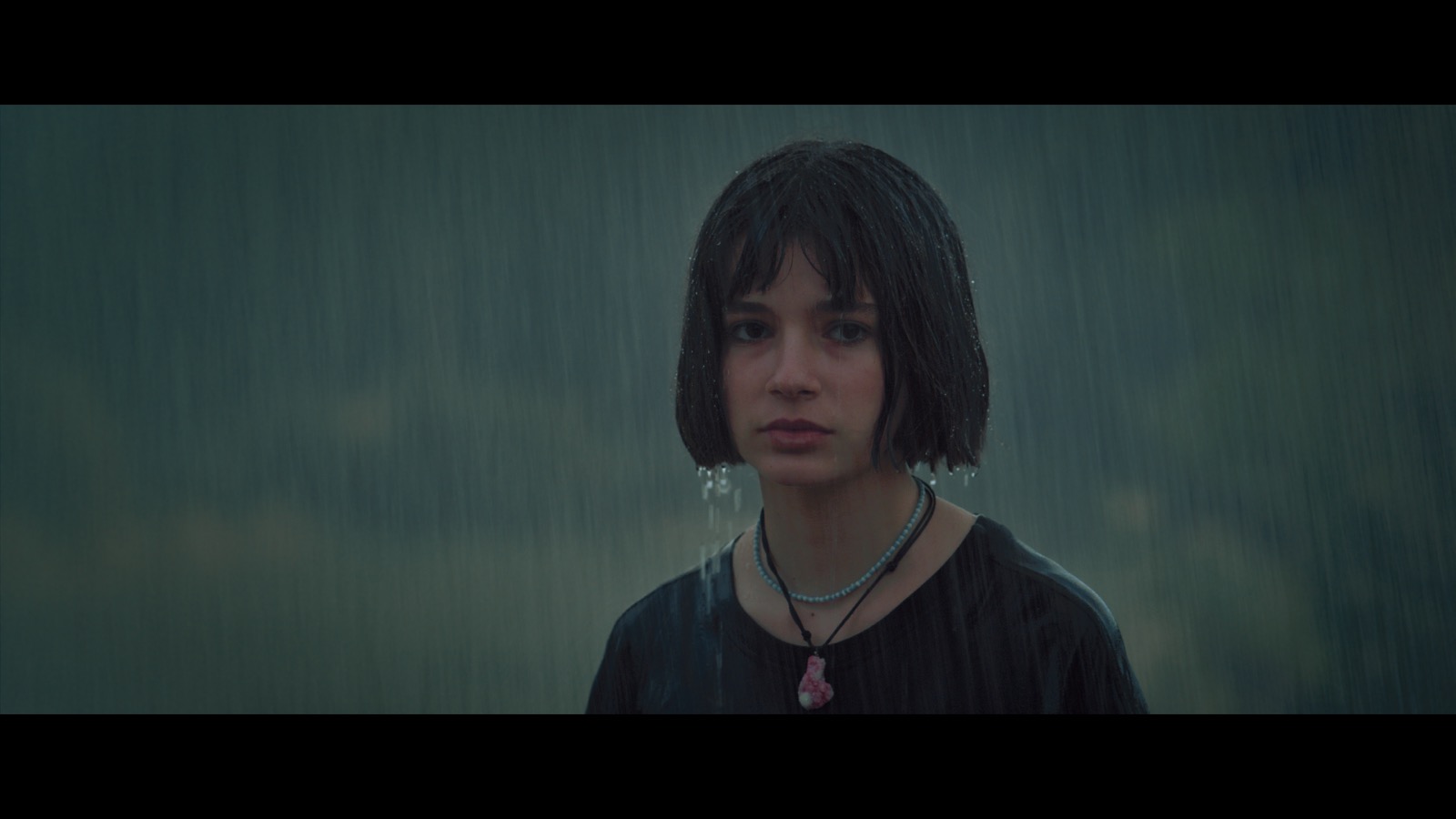 Kabahat — A girl standing in heavy rain.