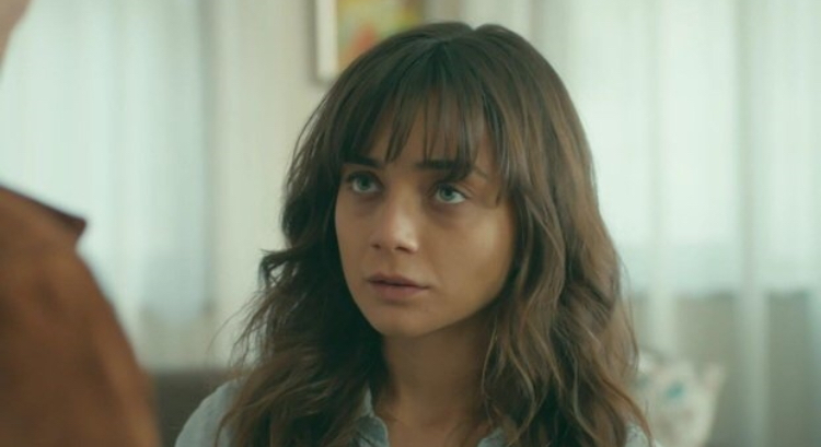 Masum Değiliz — A woman with bangs looking toward another person.