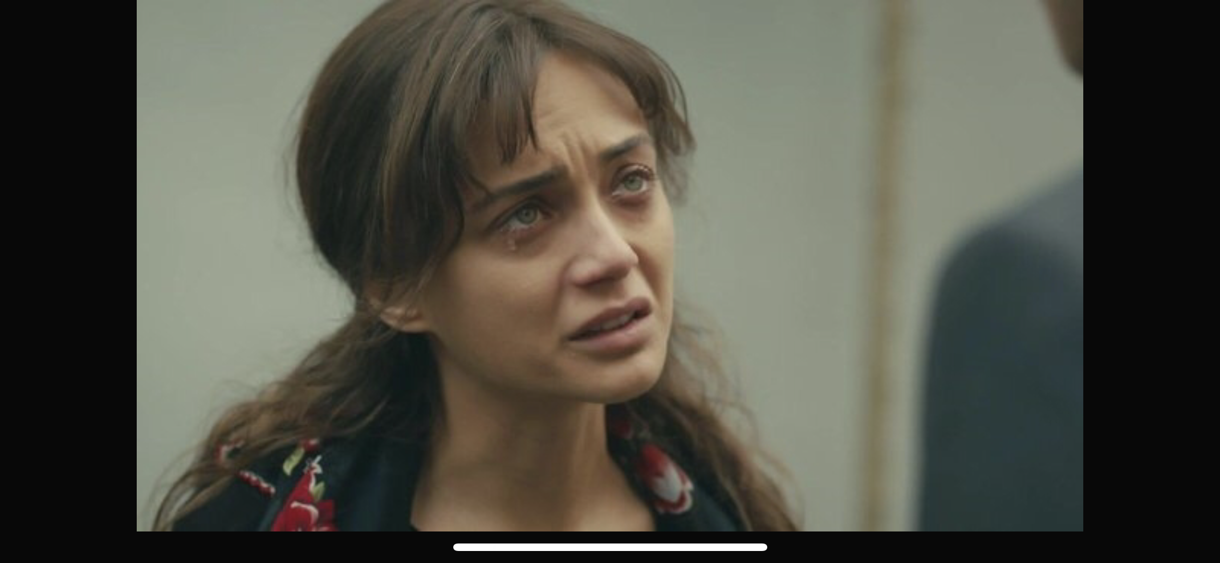 Masum Değiliz — A woman speaking indoors; supplied screenshot includes a phone navigation bar.