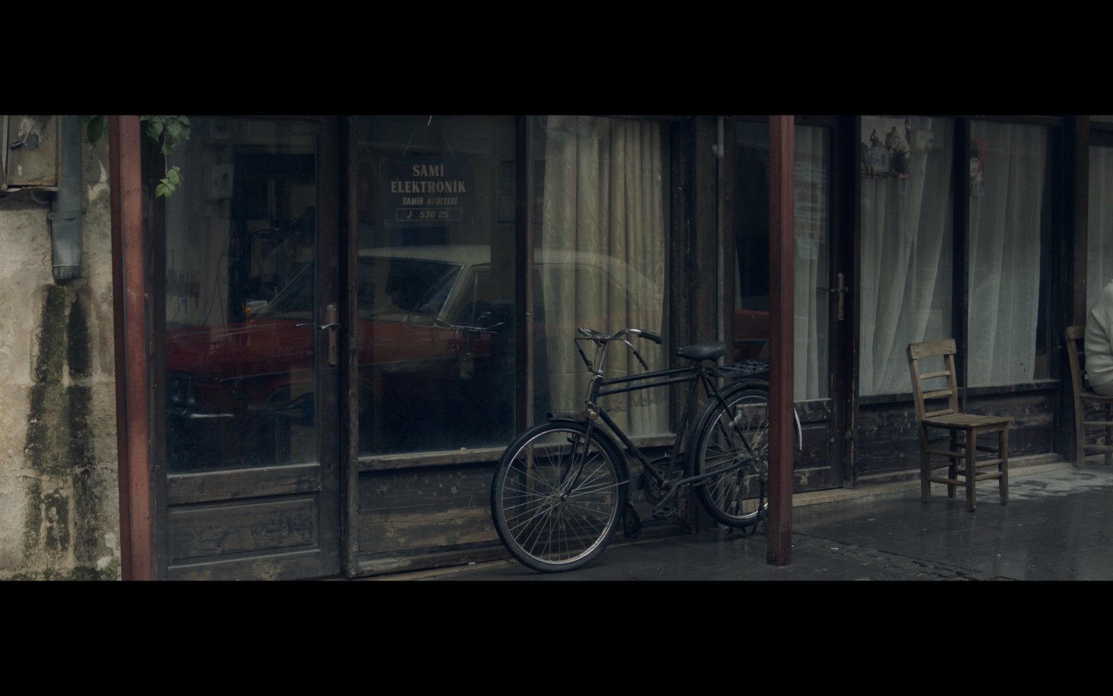 Radyo Günleri — A bicycle outside a shop on a quiet street.